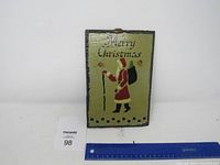 Full front view of rectangular slate Christmas sign with Santa and Merry Christmas text, ruler for size reference.