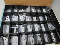 Compartmentalized plastic case with multiple white letters organized by character.