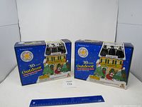 Two unopened boxes of GE 30-light outdoor Christmas light sets with festive packaging and black base bulbs.