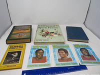 Overview of six books and magazines on a white background including baseball and football themes