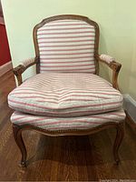 Full front view of armchair showing frame and upholstery