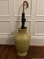 Front view of chartreuse crackle glaze vase with umbrella inserted for scale (umbrella not included)