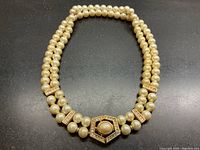 Full front view of double-strand faux pearl choker laid flat