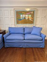 Front view of blue loveseat sofa with pillow