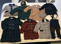 Group shot of all coats, cap and pants laid out