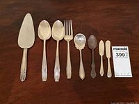 Overhead view of all eight flatware pieces on wood surface