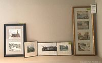 Overview of multiple framed prints and wall art arranged on a shelf including limited edition prints, Doug Forsythe prints, and a vertical multi-photo frame.