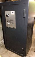 Front view of closed safe showing black exterior and silver door panel