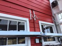 Metal grow light fixture mounted in greenhouse