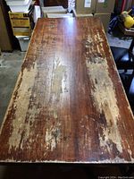 Overhead view of table top showing worn and peeling finish