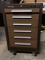 Front view of brown metal cabinet with six drawers and Kennedy logo