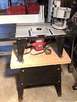 Full view of router table with Skil router installed under table and fence on top