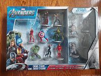 Front view of the sealed Marvel Avengers 12 Figures Collectors Edition set showing 12 colorful figures in blister packaging and bonus prototype figure.