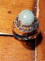 Top view of sterling silver ring indicating serpentine cabochon and ornate scrolled bezel