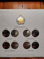 Front display of coin set showing HMS Shannon $2 coin and eight 25-cent coloured coins featuring historical figures and events from the War of 1812.