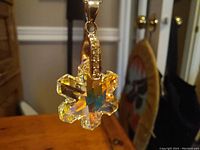 Close up front view of the Swarovski crystal snowflake pendant showing the faceted crystal and silver bail.