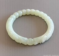 Full view of the jade bangle on a neutral background