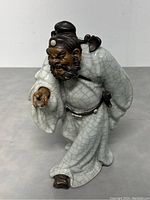Front view of Zhong Kui pottery figure showing stance and facial expression with crackled glaze robe.