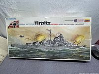 Top-down photo of the vintage Lindberg German Battleship Tirpitz model kit box showing detailed wartime illustration and branding.