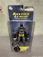 Front view of Batman figure sealed in original Justice League Classic Icons Series 1 packaging, showing card and protective blister with figure inside.