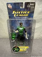 Front view of Green Lantern figure in original blister packaging showing figure and accessory clearly.