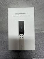 Front view of Ledger Nano S box showing branding and device image.