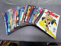 Angle showing a spread of 40 X-Men comic books fanned out with vibrant colorful covers.