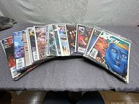 Photo of multiple comic books fanned out showing various X-Men and Teen Titans covers.