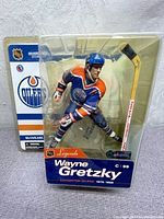 Front view of sealed Wayne Gretzky NHL figurine in Edmonton Oilers uniform, showing detailed figure and packaging.