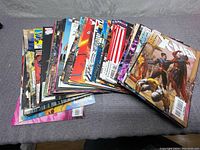 Stack of X-Men comic books spread out showing various cover arts and spine titles, indicating a larger lot with multiple issues.