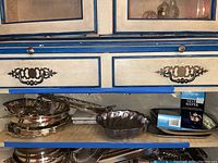 Photo showing silver plated divided serving bowl, scallop-edged bowl, and silver keeper container box on shelf