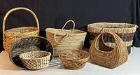 Photo showing all seven baskets arranged in two rows, highlighting the wide variety of shapes, weaving types, and sizes.