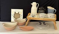 Full lot arranged on table including microwave cover, bowls, shortbread pan, coffee jug, milk jug, cups, egg cups and wooden tray