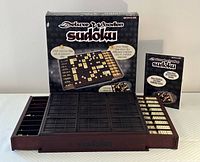 Wooden Sudoku game board displayed with numeric tiles, dark wood frame, original box, and instruction booklet