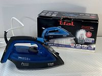 Blue and black T-Fal Ultraglide Pro iron displayed with its original box packaging