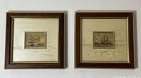 Pair of two framed art pieces by Gold Art of Geneva on a white textured wall, wooden frames, gold inner trim, depicting historic ships.