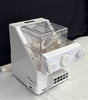 White CTC Pasta Express electric pasta maker with transparent lid and control knobs on front.