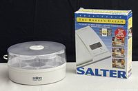 Salton yogurt maker with lid and Salter kitchen scale box next to it.