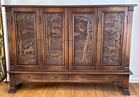 Full front view showing five carved doors and three drawers