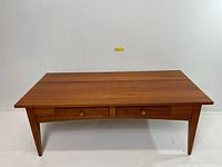 Overall front view showing table top, drawers, and tapered legs