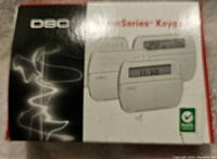 Blurry photo of DSC PowerSeries PK5508 keypad original box showing product image and logo.