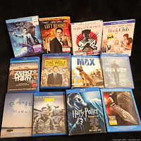 Assorted Blu-Ray movie cases including titles like Self/Less, Left Behind, Wolverine, Book Club, etc.