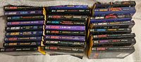 Top and side view of around 38 Star Trek The Next Generation paperback novels arranged in stacks with visible titles and mostly black or dark-colored spines.