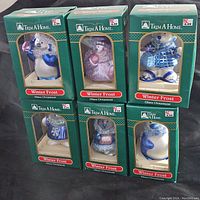 Lot of six Trim A Home Winter Frost glass ornaments in original green boxes, showing front and arrangement of the ornaments.