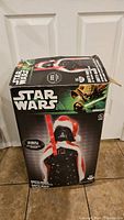 Box showing Star Wars branding and image of the Darth Vader holiday decoration with light-up feature.