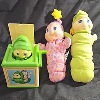 Three items shown: two plush Glo-Worm dolls and one green Jack In The Box toy with worm figure popping out.