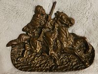 Front angle close-up of bronze figurine showing Bedouin warrior on horse.