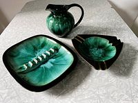 Three Blue Mountain Pottery pieces: pitcher, triangular ashtray, rectangular ashtray