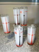 Five frosted hi-ball glasses with CN Tower orange graphics on front, showing logo and tower illustration