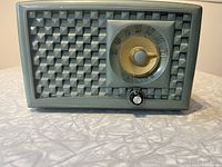 Front view of vintage Philips AM radio showing textured grille and tuning dial